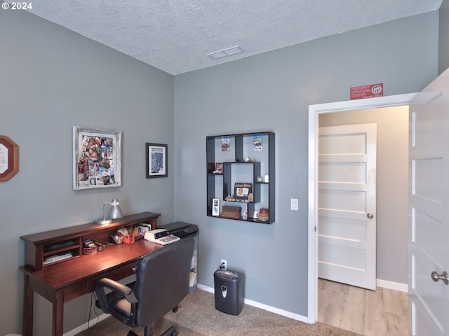 office featuring a textured ceiling and light wood-type flooring