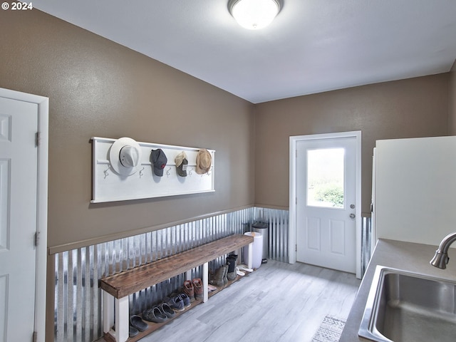 mudroom with light hardwood / wood-style floors and sink