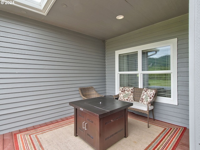 exterior space featuring a skylight, light hardwood / wood-style flooring, and wood walls