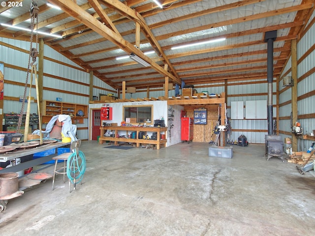 garage with a workshop area and a wood stove