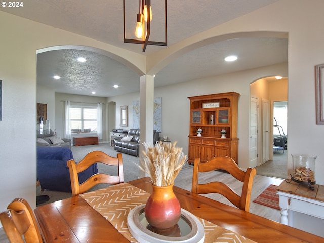 dining area with carpet flooring and a textured ceiling