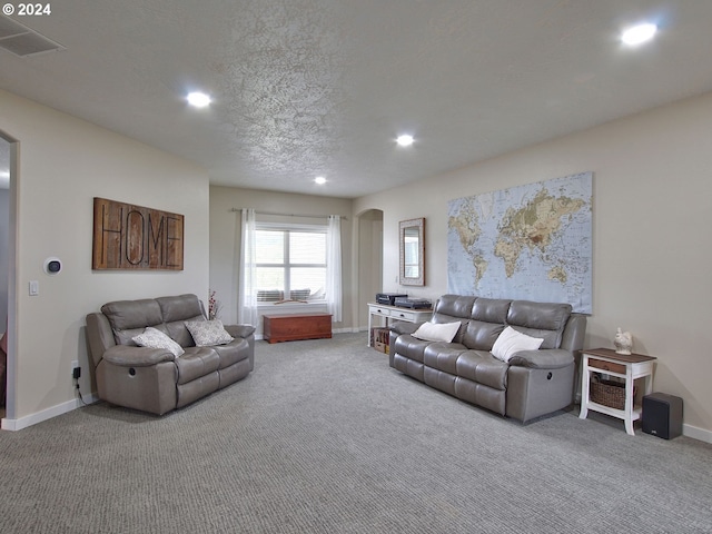 living room featuring carpet floors and a textured ceiling