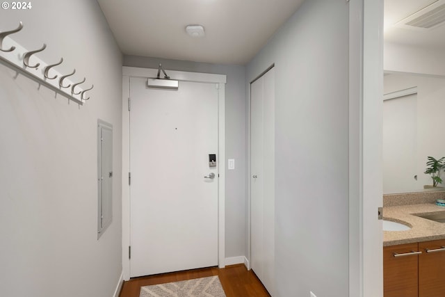 entryway featuring dark wood-type flooring and electric panel