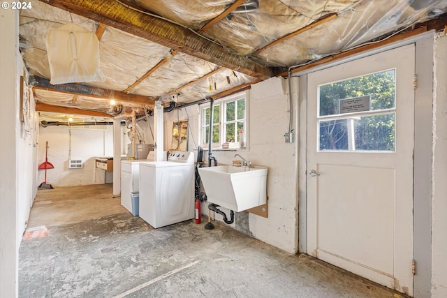 basement with separate washer and dryer and sink