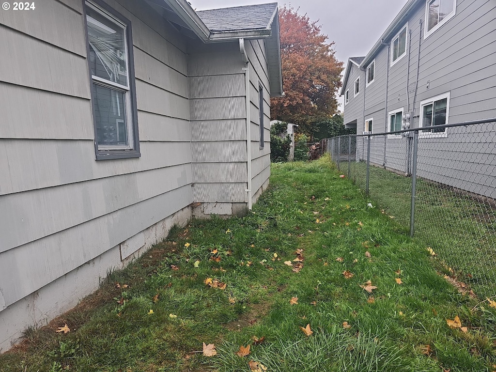 view of side of property with a lawn