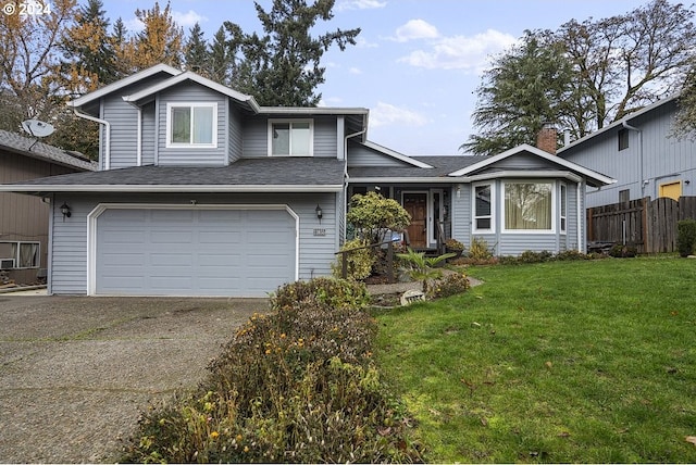 view of front of property featuring a front yard and a garage