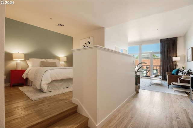 bedroom featuring light hardwood / wood-style floors and access to outside