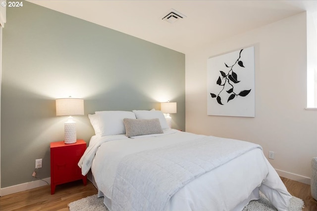 bedroom with hardwood / wood-style flooring