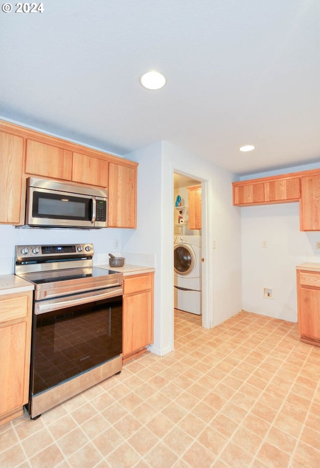 kitchen featuring washer / clothes dryer and appliances with stainless steel finishes