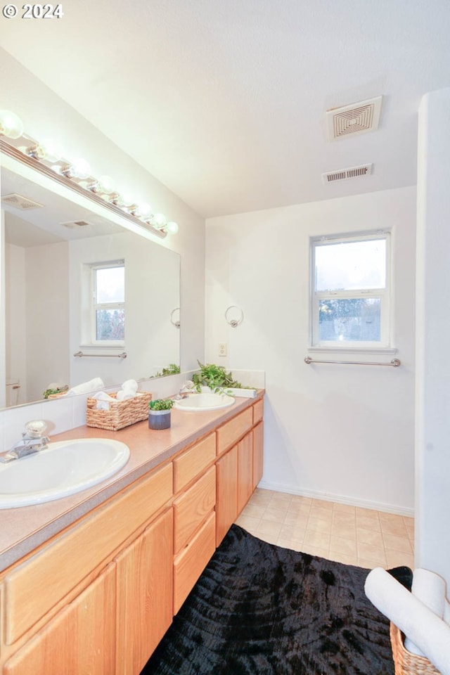 bathroom with tile patterned floors and vanity