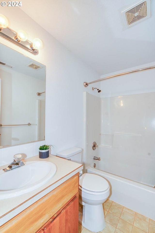 full bathroom featuring toilet, vanity, tile patterned floors, and shower / bathing tub combination