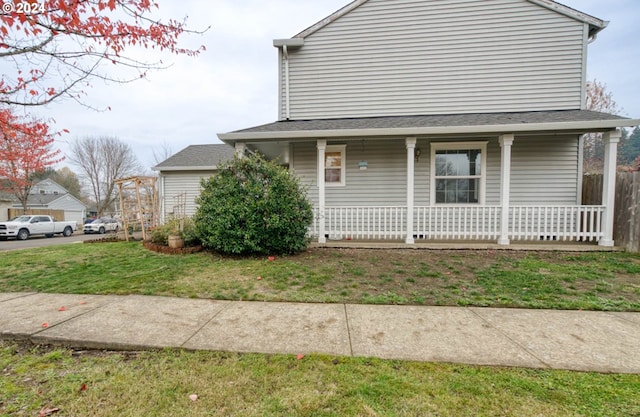 view of side of property with a yard and covered porch