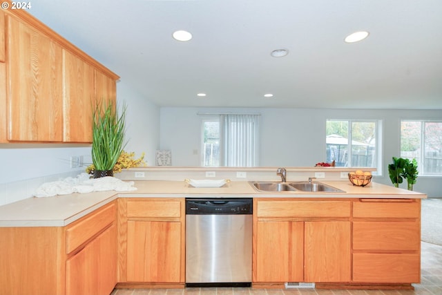 kitchen featuring dishwasher, sink, and light brown cabinets