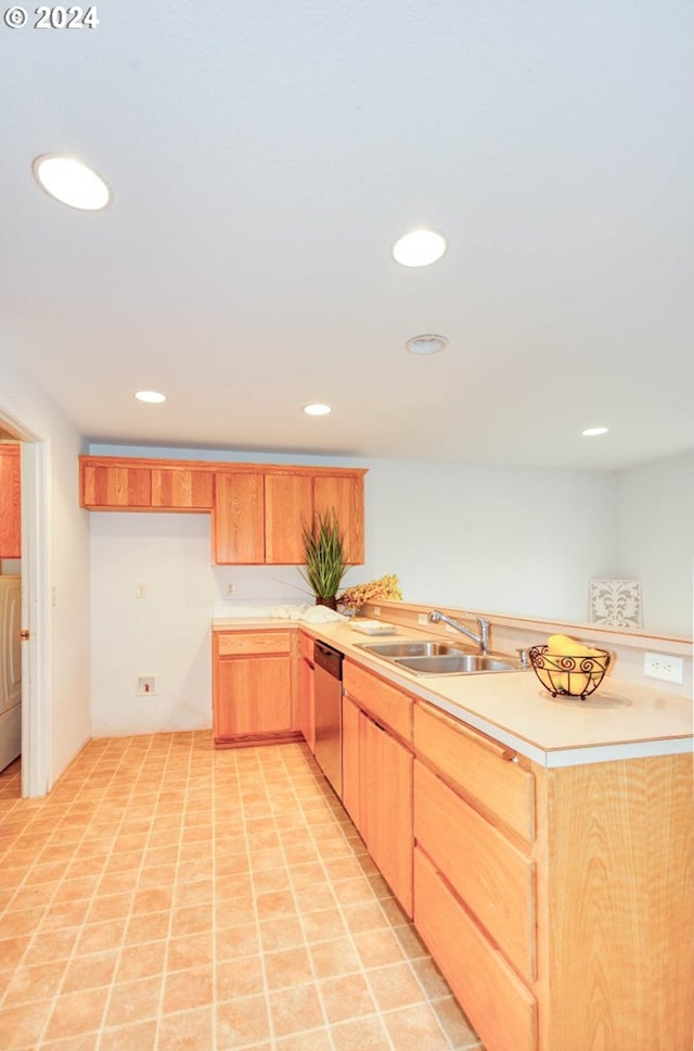 kitchen with sink, stainless steel dishwasher, washer / clothes dryer, and light brown cabinets