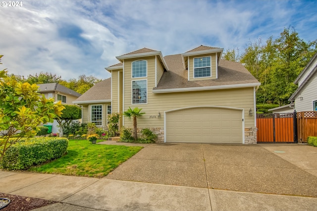 view of front of house featuring a front yard and a garage