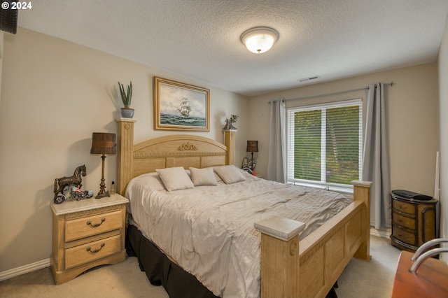 carpeted bedroom with a textured ceiling