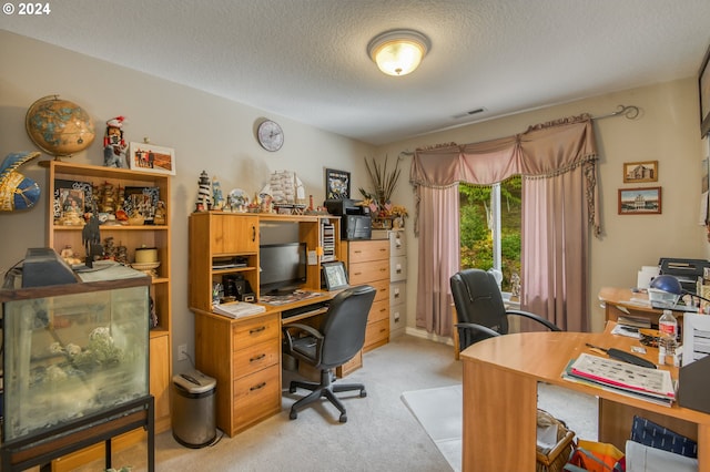 office area with light carpet and a textured ceiling