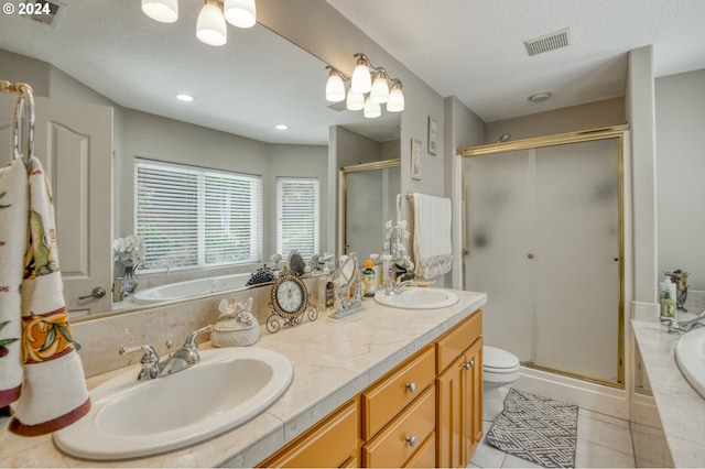 full bathroom featuring vanity, a textured ceiling, independent shower and bath, tile patterned flooring, and toilet