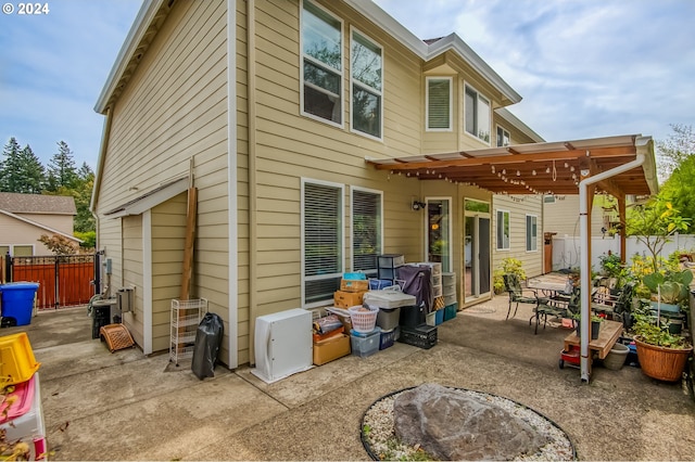 rear view of house with a patio and a pergola