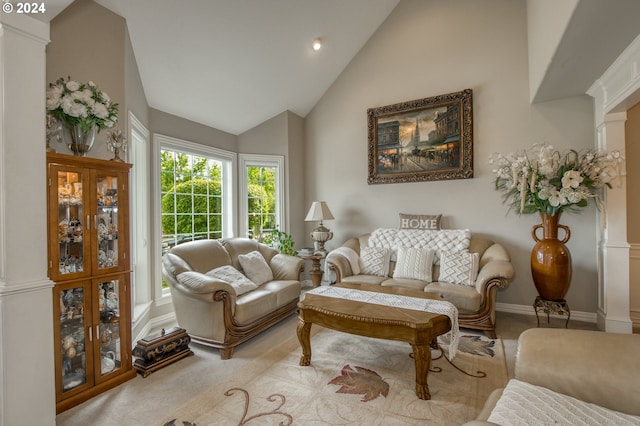 living room featuring light colored carpet, ornate columns, and high vaulted ceiling