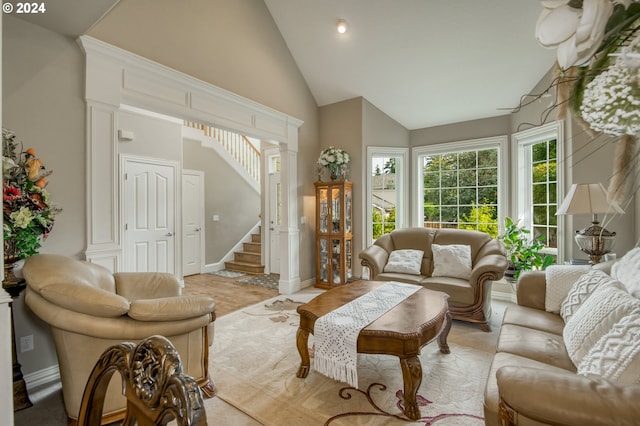 living room with high vaulted ceiling and decorative columns