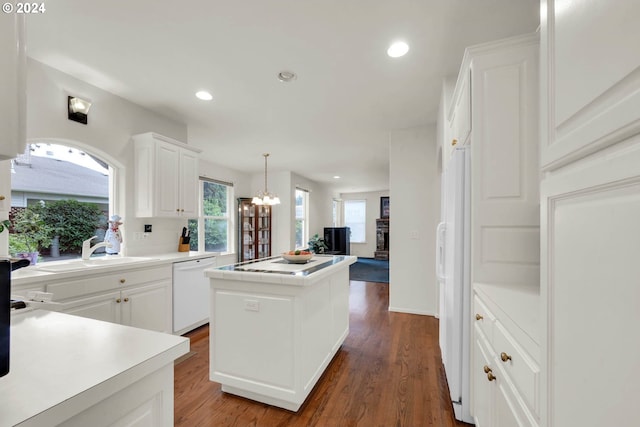 kitchen featuring dark hardwood / wood-style floors, white dishwasher, sink, and a kitchen island