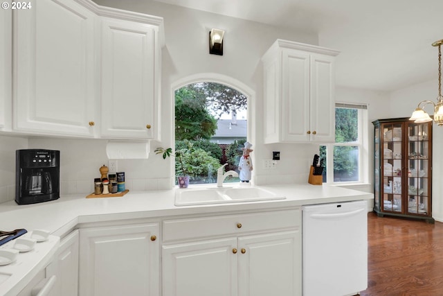 kitchen featuring dishwasher, dark hardwood / wood-style floors, hanging light fixtures, sink, and white cabinets