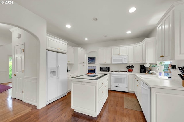 kitchen featuring sink, a center island, white cabinetry, white appliances, and dark hardwood / wood-style flooring