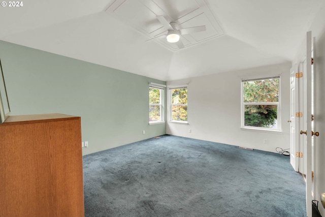 empty room with ceiling fan, carpet, vaulted ceiling, and plenty of natural light