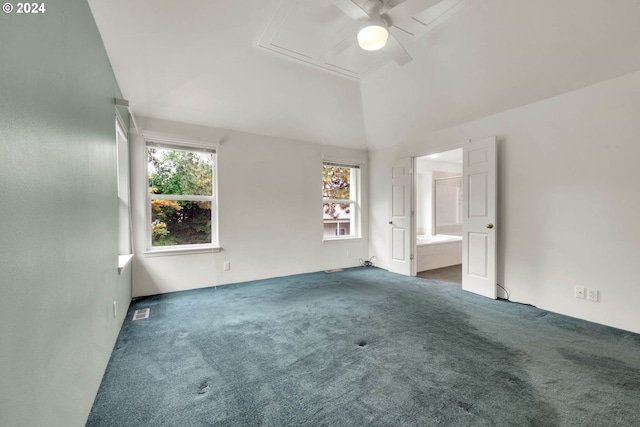 unfurnished bedroom featuring connected bathroom, carpet flooring, multiple windows, and ceiling fan