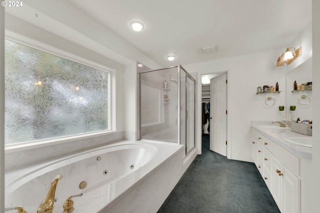 bathroom featuring vanity and independent shower and bath