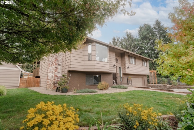 rear view of house with a lawn and a garage