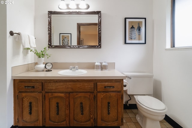 bathroom with tile patterned flooring, vanity, and toilet