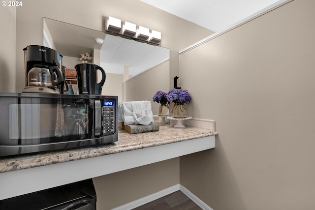 details with black microwave, light countertops, and baseboards