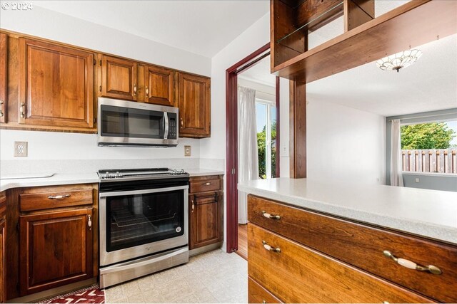 kitchen featuring light tile patterned floors and stainless steel appliances