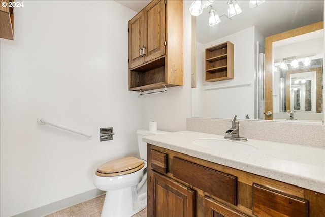 bathroom with vanity, tile patterned flooring, and toilet