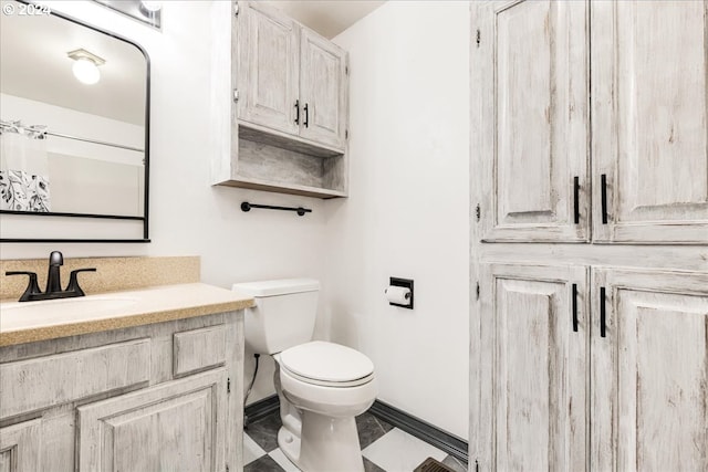 bathroom with vanity, toilet, and tile patterned flooring