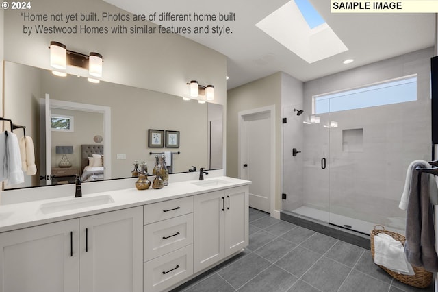 bathroom featuring a skylight, vanity, and an enclosed shower