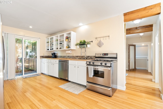 kitchen with open shelves, appliances with stainless steel finishes, light wood-style floors, and white cabinets