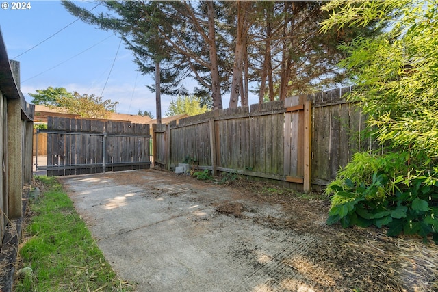 view of gate with a fenced backyard