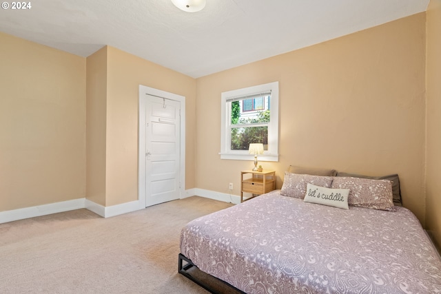 carpeted bedroom featuring baseboards