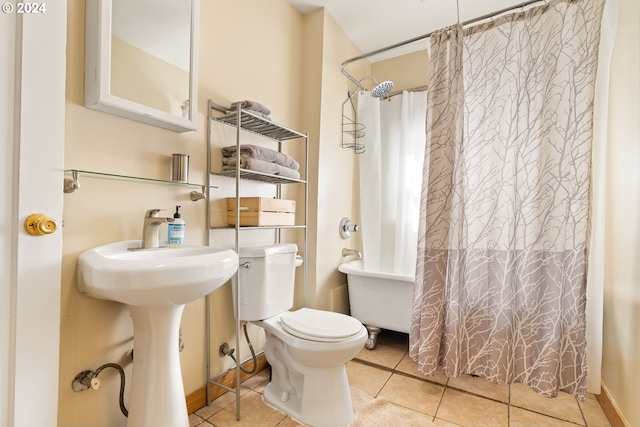 bathroom featuring shower / bathtub combination with curtain, toilet, and tile patterned floors