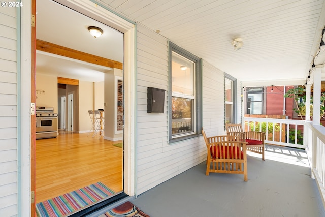 view of patio / terrace featuring covered porch and electric panel