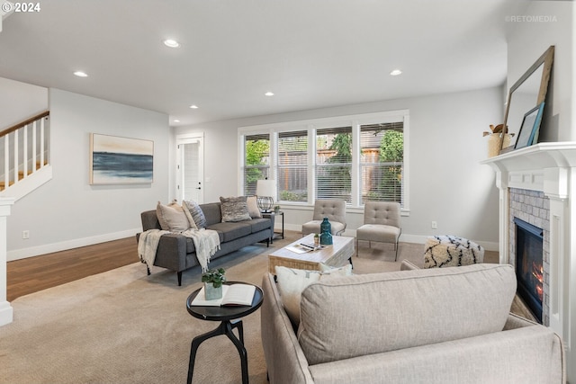 living room featuring a fireplace and light hardwood / wood-style flooring