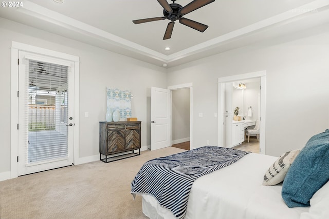 bedroom with access to outside, light carpet, connected bathroom, a raised ceiling, and ceiling fan