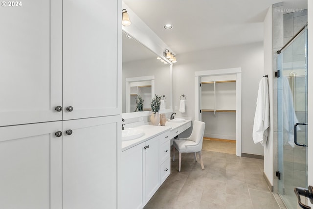 bathroom with walk in shower and vanity