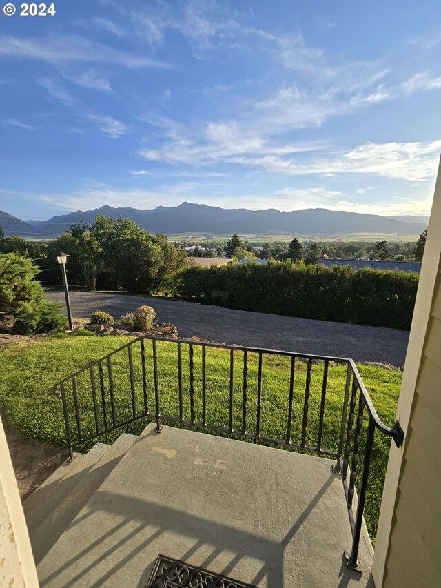 exterior space featuring a balcony and a mountain view