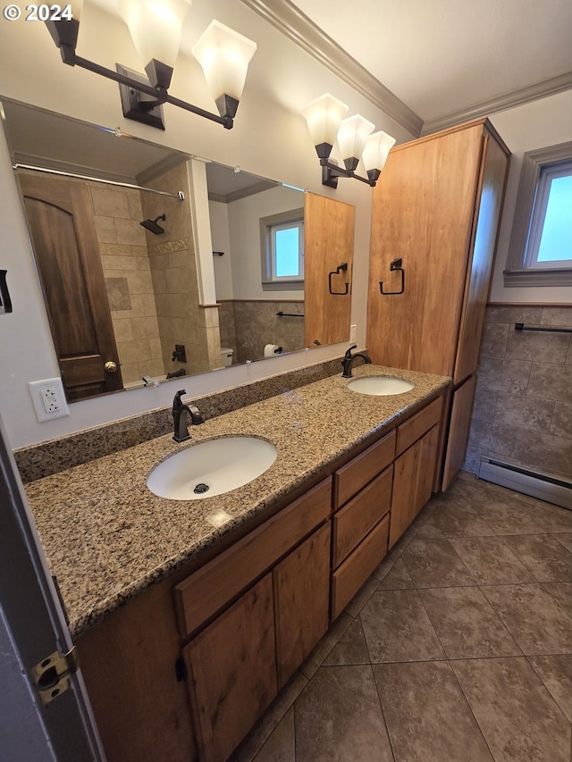 bathroom with tiled shower, crown molding, tile patterned floors, and vanity