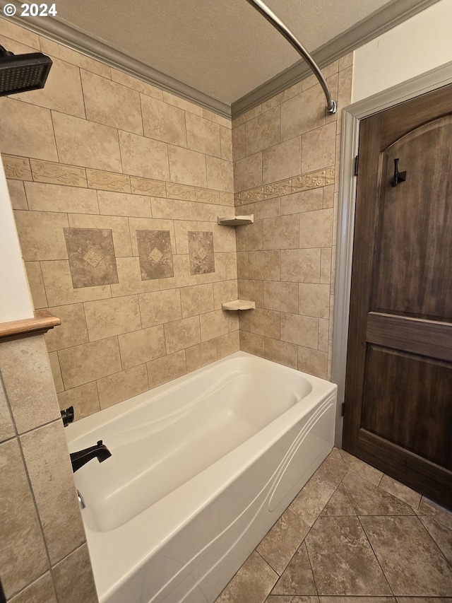 bathroom with ornamental molding, tile patterned floors, a textured ceiling, tile walls, and tiled shower / bath combo