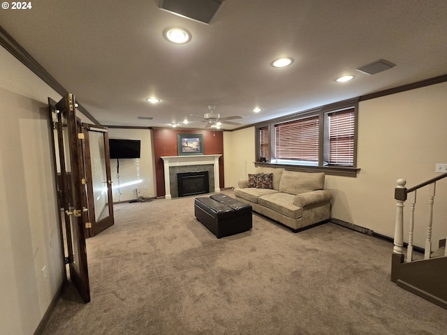 carpeted living room featuring ceiling fan, a barn door, ornamental molding, and a fireplace